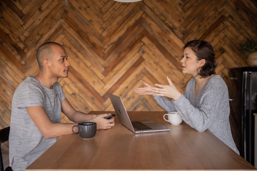 Two people talking at a coffee shop