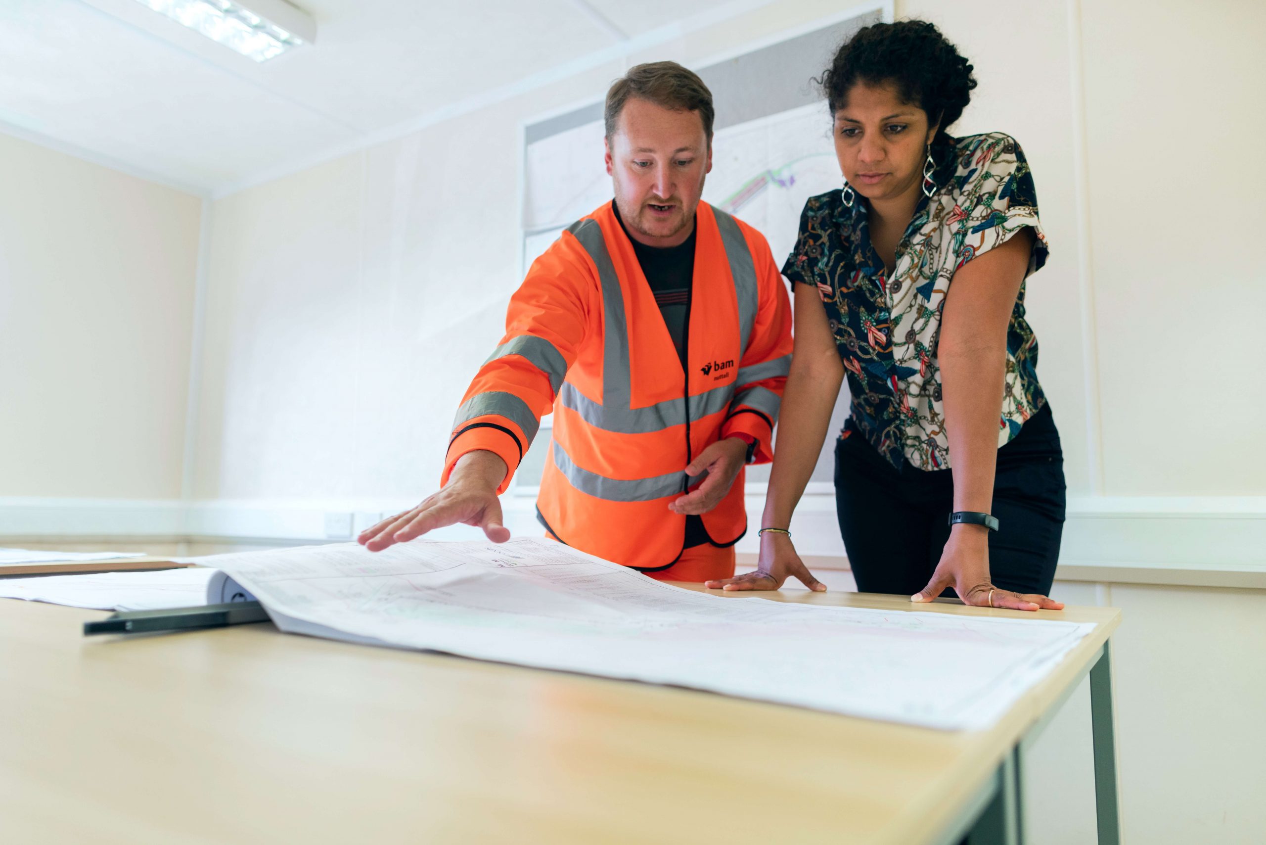 Two people looking over building plans